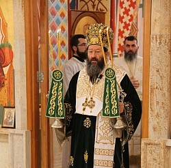 Svečana scena Svete arhijerejske liturgije u Crkvi Preobraženja Gospodnjeg, koju je služio mitropolit žički Justin u raskošnoj zlatnoj odori, okružen sveštenstvom i vernicima u molitvenoj tišini pred bogatim ikonostasom.