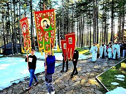 Тренутак повратка литијске поворке пред улаз у Храм Преображења Господњег на Златибору. Фотографија приказује окупљени народ испред каменог портала цркве, док свештенство припрема завршну молитву. Видљиви су остаци снега у угловима порте, што подсећа на специфичну планинску климу Златибора у априлу. Ова слика заокружује циклус прославе Врбице, приказујући масовност и посвећеност парохијана и гостију током васкршњих празника у овом делу Србије.